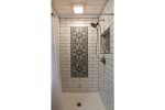 Main Level Bathroom offers walk in tile shower